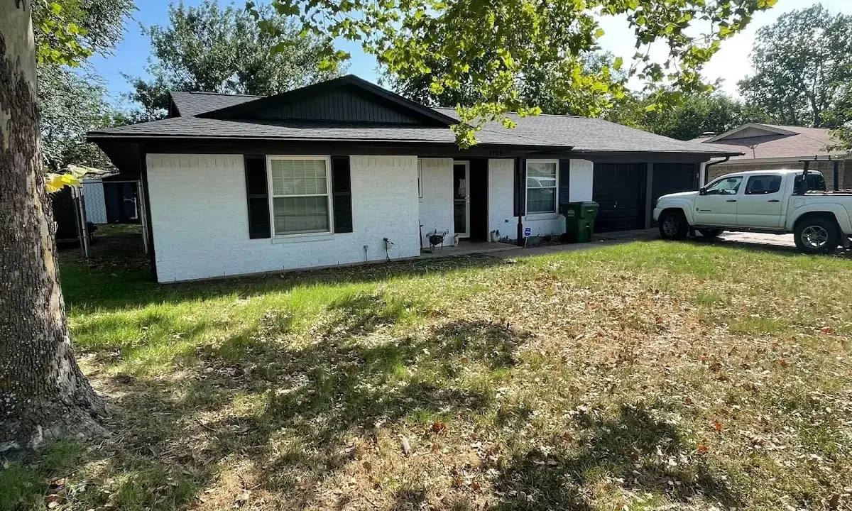 Professional roofing crew working on a residential roof in East Rutherford